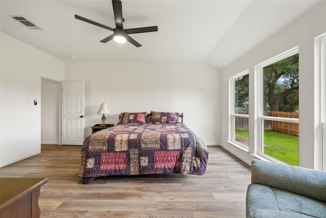 608 Haleys Cv, Leander, TX 78641 - bedroom featuring vaulted ceiling, wood finished floors, ceiling fan, and access to exterior