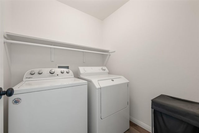 608 Haleys Cv, Leander, TX 78641 - laundry room featuring washer and clothes dryer and wood finished floors