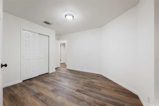 608 Haleys Cv, Leander, TX 78641 - unfurnished bedroom featuring dark wood-type flooring and a closet