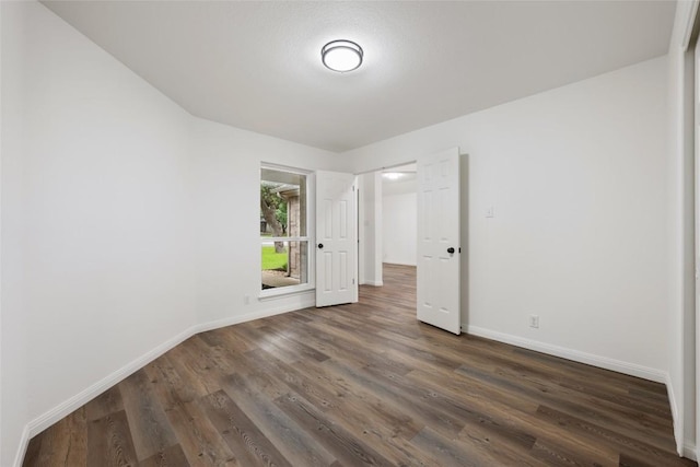 608 Haleys Cv, Leander, TX 78641 - unfurnished room with baseboards and dark wood finished floors