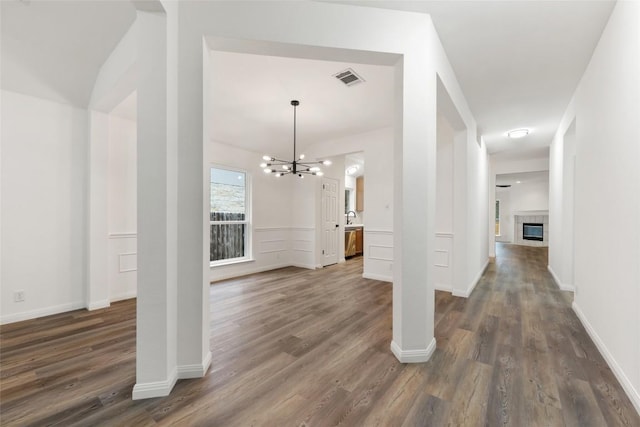 608 Haleys Cv, Leander, TX 78641 - foyer featuring a chandelier, dark wood-style flooring, and a tile fireplace
