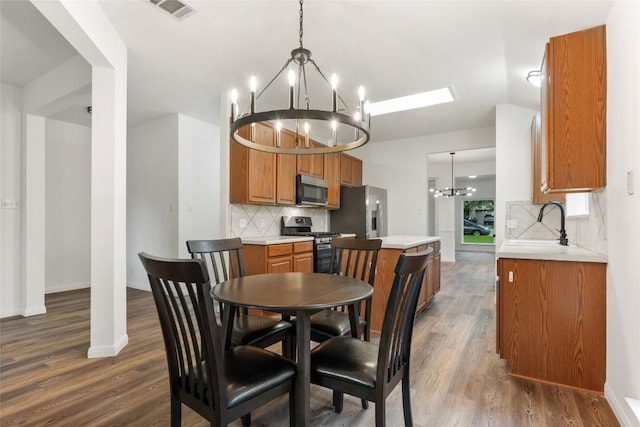 608 Haleys Cv, Leander, TX 78641 - dining space with a chandelier and dark wood-type flooring