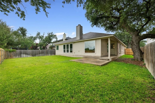 608 Haleys Cv, Leander, TX 78641 - rear view of house with a patio, a chimney, a fenced backyard, and stucco siding