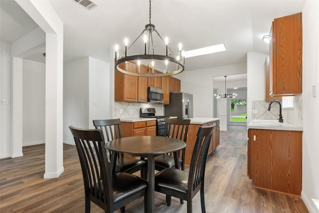 608 Haleys Cv, Leander, TX 78641 - dining area featuring a chandelier and dark wood-style flooring