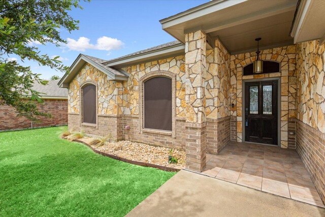 5012 Jeanine Dr, Temple, TX 76502 - entrance to property featuring stone siding, a yard, and brick siding
