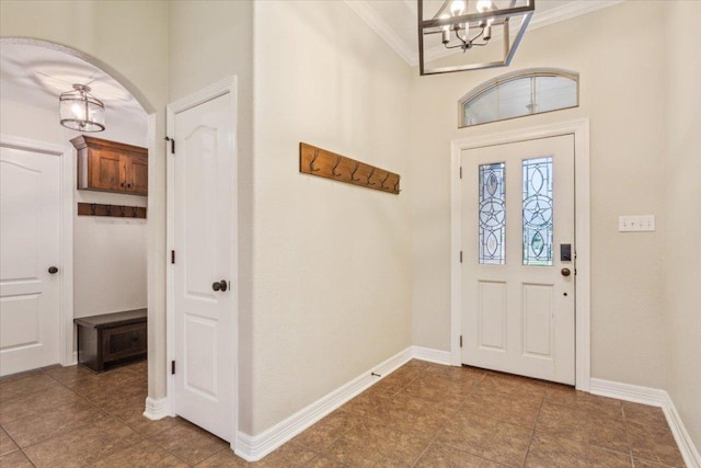 5012 Jeanine Dr, Temple, TX 76502 - tiled entryway with a chandelier, crown molding, and arched walkways