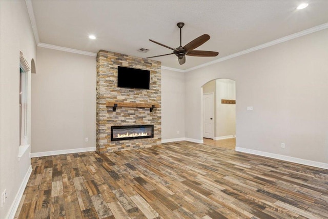 5012 Jeanine Dr, Temple, TX 76502 - unfurnished living room with a ceiling fan, wood finished floors, arched walkways, a stone fireplace, and recessed lighting