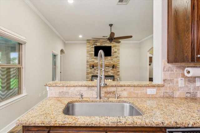5012 Jeanine Dr, Temple, TX 76502 - kitchen featuring light stone countertops, ornamental molding, a ceiling fan, arched walkways, and recessed lighting