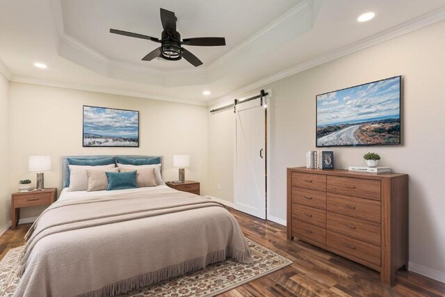 5012 Jeanine Dr, Temple, TX 76502 - bedroom with a barn door, a tray ceiling, dark wood-type flooring, crown molding, and recessed lighting