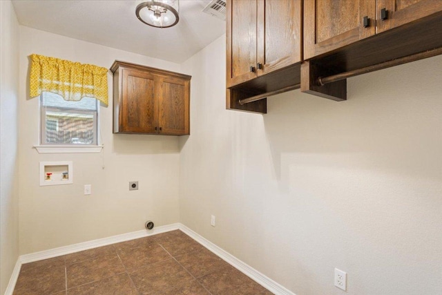 5012 Jeanine Dr, Temple, TX 76502 - laundry room with cabinet space, electric dryer hookup, hookup for a washing machine, and dark tile patterned floors