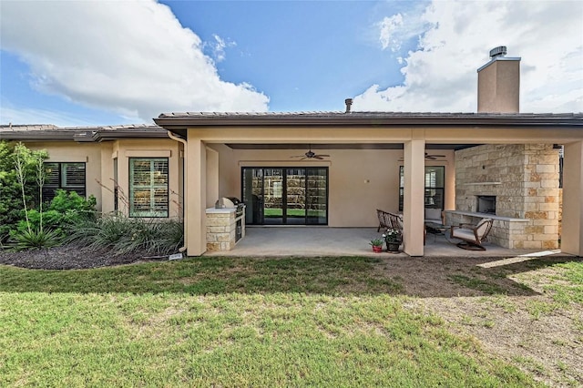 120 Delfino Pl, Horseshoe Bay, TX 78657 - rear view of property featuring ceiling fan, a yard, a patio, stucco siding, and a chimney