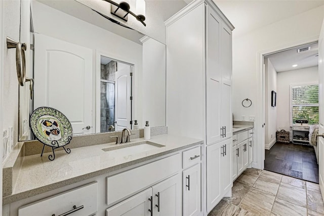 120 Delfino Pl, Horseshoe Bay, TX 78657 - bathroom featuring vanity, a shower stall, and marble look tiles