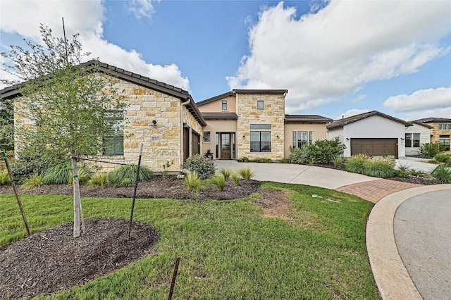 120 Delfino Pl, Horseshoe Bay, TX 78657 - modern home with an attached garage, stone siding, driveway, and a front yard