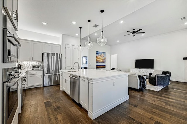 120 Delfino Pl, Horseshoe Bay, TX 78657 - kitchen with stainless steel appliances, ceiling fan, recessed lighting, dark wood-style flooring, and backsplash