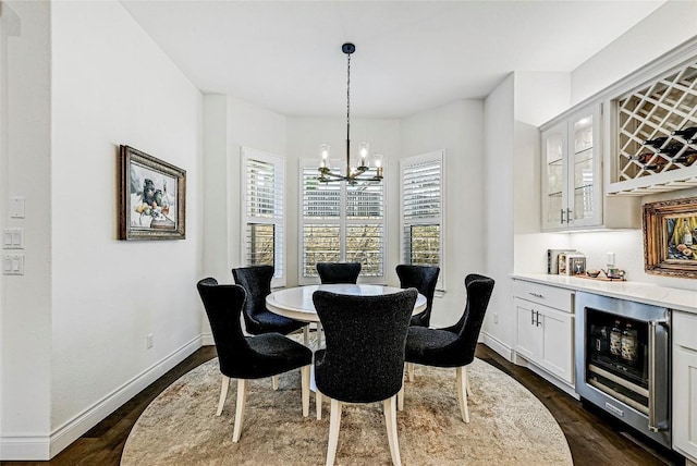 120 Delfino Pl, Horseshoe Bay, TX 78657 - dining space with a chandelier, beverage cooler, a dry bar, and dark wood-style flooring