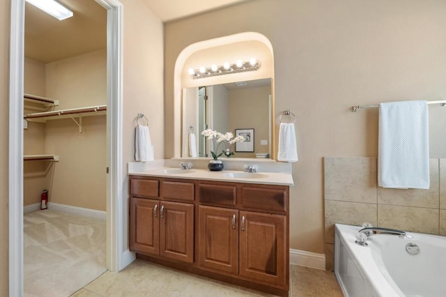 11900 Timber Heights Dr, Austin, TX 78754 - bathroom featuring double vanity, a bath, and a spacious closet