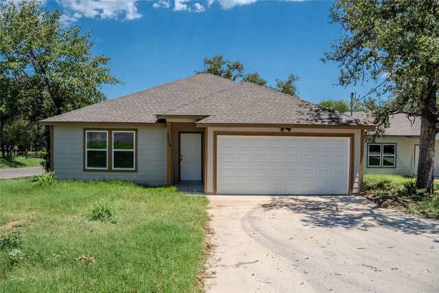 2230 Mc Arthur Ave, Kingsland, TX 78639 - view of front of house featuring driveway, an attached garage, and roof with shingles
