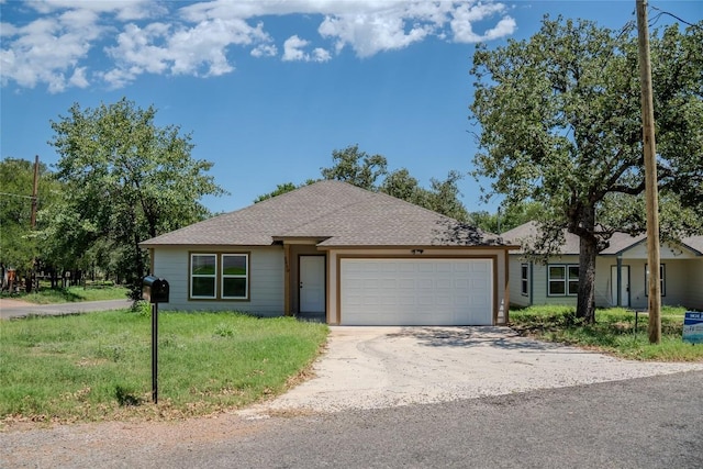 2230 Mc Arthur Ave, Kingsland, TX 78639 - single story home with an attached garage, driveway, roof with shingles, and a front lawn