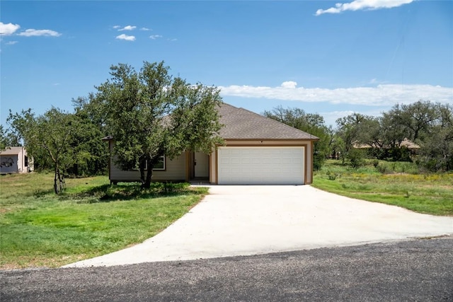 2182 Mcarthur Ave, Kingsland, TX 78639 - view of front of house with an attached garage, concrete driveway, a front lawn, and roof with shingles