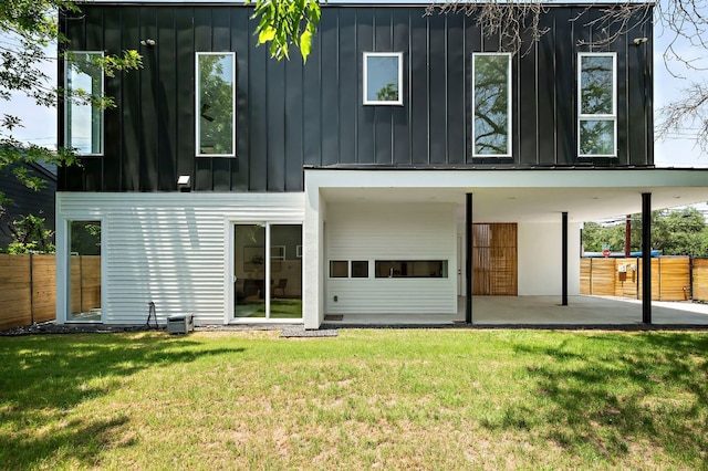 5507 Manor Rd Unit B, Austin, TX 78723 - rear view of property with board and batten siding and a patio area