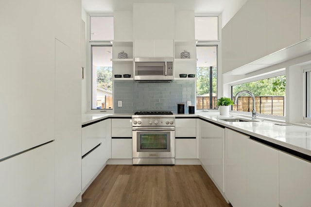 5507 Manor Rd Unit B, Austin, TX 78723 - kitchen featuring appliances with stainless steel finishes, open shelves, white cabinetry, and modern cabinets