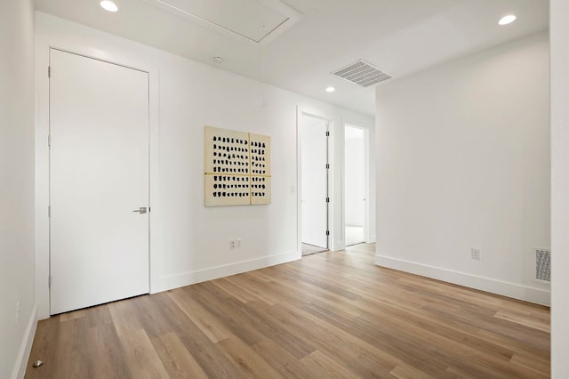 5507 Manor Rd Unit B, Austin, TX 78723 - unfurnished room featuring wood finished floors, recessed lighting, and attic access