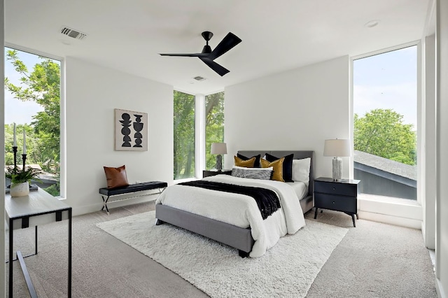 5507 Manor Rd Unit B, Austin, TX 78723 - carpeted bedroom with a wall of windows, multiple windows, and ceiling fan
