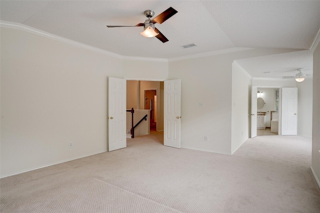 7604 Napier Trl, Austin, TX 78729 - spare room featuring a ceiling fan, light carpet, vaulted ceiling, and ornamental molding