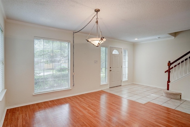 7604 Napier Trl, Austin, TX 78729 - foyer with crown molding, stairs, a textured ceiling, and light tile patterned floors