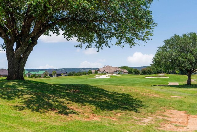 2004 Ballinger Dr, Spicewood, TX 78669 - surrounding community with a yard and view of golf course