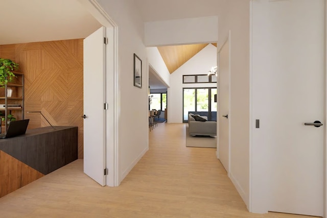 2004 Ballinger Dr, Spicewood, TX 78669 - corridor with vaulted ceiling, light wood-style flooring, and wooden walls