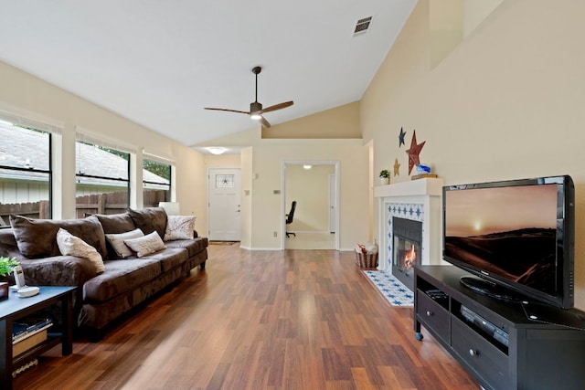 3008 Siskin Dr, Austin, TX 78745 - living area featuring wood finished floors, a ceiling fan, a tiled fireplace, and lofted ceiling
