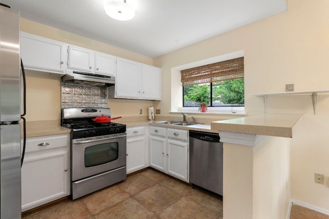 3008 Siskin Dr, Austin, TX 78745 - kitchen with stainless steel appliances, under cabinet range hood, light countertops, and white cabinets