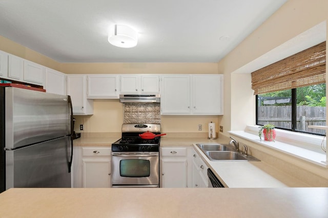 3008 Siskin Dr, Austin, TX 78745 - kitchen featuring stainless steel appliances, range hood, light countertops, and white cabinets