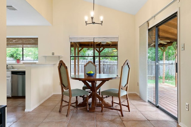 3008 Siskin Dr, Austin, TX 78745 - dining room featuring a chandelier, light tile patterned flooring, and vaulted ceiling