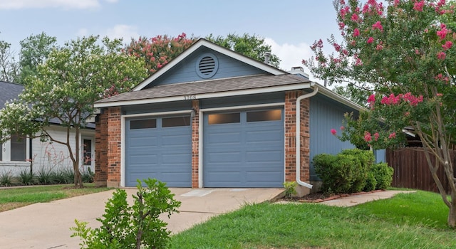 3008 Siskin Dr, Austin, TX 78745 - view of front of house with concrete driveway, brick siding, an outdoor structure, roof with shingles, and a garage
