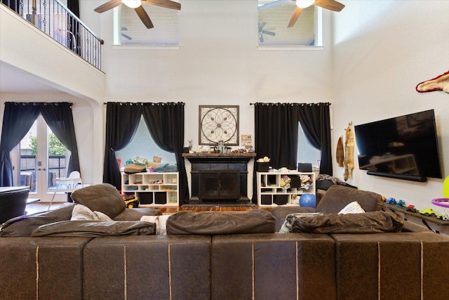 1915 Los Santos Dr, San Marcos, TX 78666 - living area featuring a ceiling fan, a towering ceiling, and a fireplace with raised hearth
