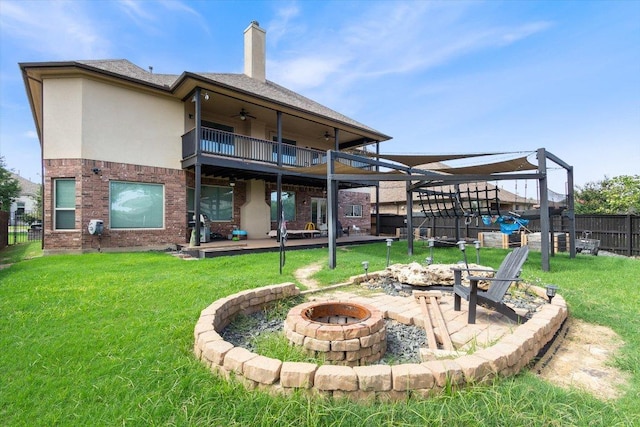 1915 Los Santos Dr, San Marcos, TX 78666 - back of property with an outdoor fire pit, a balcony, a patio, and a ceiling fan