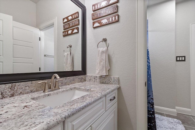 1915 Los Santos Dr, San Marcos, TX 78666 - bathroom featuring vanity, a textured wall, and tile patterned floors