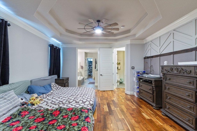 1915 Los Santos Dr, San Marcos, TX 78666 - bedroom with a tray ceiling, light wood finished floors, ensuite bathroom, ornamental molding, and a ceiling fan