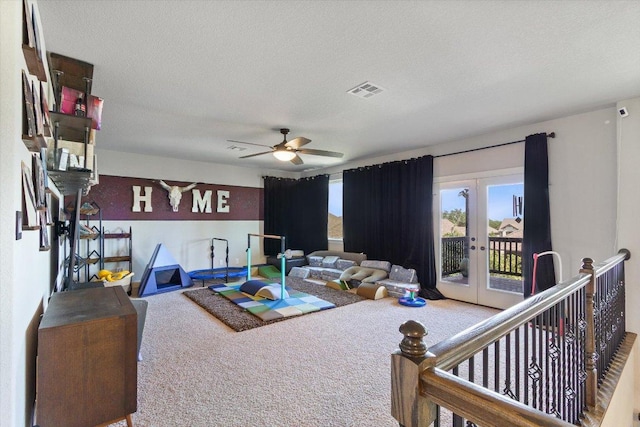 1915 Los Santos Dr, San Marcos, TX 78666 - living area featuring carpet floors, french doors, a textured ceiling, and a ceiling fan