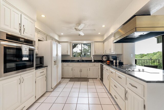 6033 Mount Bonnell Cv, Austin, TX 78731 - kitchen featuring black appliances, a ceiling fan, light tile patterned floors, dark countertops, and recessed lighting