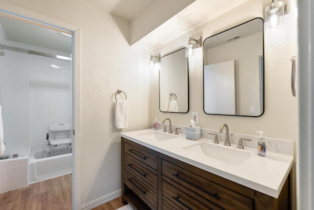 6033 Mount Bonnell Cv, Austin, TX 78731 - bathroom featuring double vanity, wood finished floors, and  shower combination