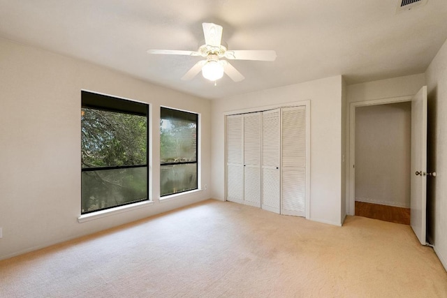 6033 Mount Bonnell Cv, Austin, TX 78731 - unfurnished bedroom with light colored carpet, a closet, and ceiling fan