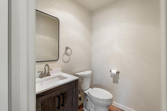 6033 Mount Bonnell Cv, Austin, TX 78731 - half bathroom featuring vanity, a textured wall, and wood finished floors