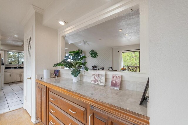 6033 Mount Bonnell Cv, Austin, TX 78731 - kitchen featuring brown cabinetry, ceiling fan, light countertops, and recessed lighting