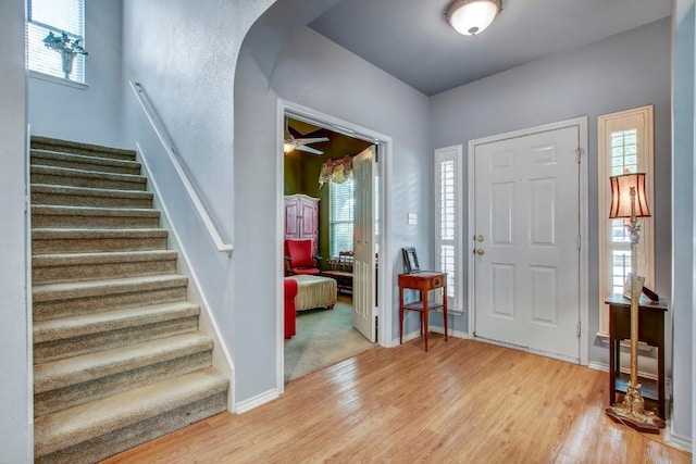 1203 Cardigan St, Cedar Park, TX 78613 - foyer entrance featuring arched walkways, light wood-style floors, and stairs