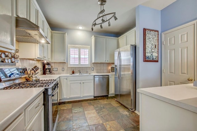 1203 Cardigan St, Cedar Park, TX 78613 - kitchen featuring appliances with stainless steel finishes, exhaust hood, decorative backsplash, light countertops, and stone finish flooring