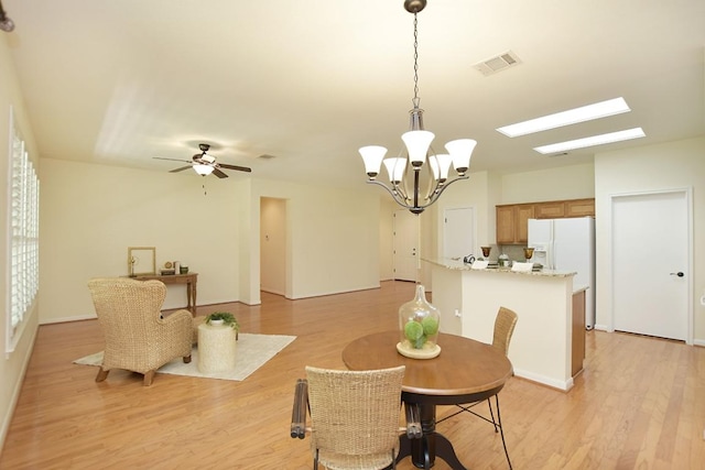 101 Bass St, Georgetown, TX 78633 - dining area with light wood-type flooring, a chandelier, a skylight, and a ceiling fan