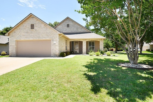 101 Bass St, Georgetown, TX 78633 - view of front of home with a garage, a front yard, concrete driveway, and stone siding